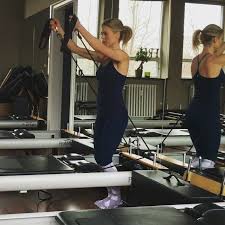 Front And Medial Deltoid Raises Standing In The Well Of The Reformer Hard One Upper Body Workout But The R Pilates Reformer Upper Body Workout Fitness Body