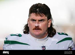 New York Jets guard Dan Feeney stands