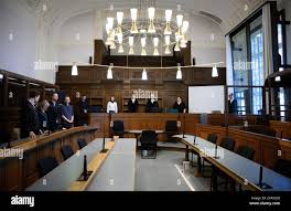 16 October 2024, Berlin: Arne Semsrott (4th from left), editor-in-chief of  the internet portal "FragdenStaat", stands with his lawyers Benjamin Lück  (l-r), Hannah Vos and Lukas Theune in the hearing room at