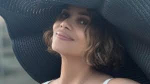 Halle Berry, 58, shows off her age-defying looks in a chic black and white  swimsuit as she poses up a storm in California