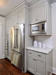 We're remodeling our kitchen and need to install upper cabinets that are low enough to comfortably reach the shelves but high enough so that the countertop doesn't feel cramped. Upper Kitchen Cabinets Level Or Varied Height Kitchen Remodel Small Painted Kitchen Cabinets Colors Studio Kitchen