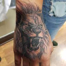 Lion Hand Tattoo By Chad Mr Blacklight Liontattoo Handtattoo Mrwilliamstattooco Realistictattoos Portraittat Hand Tattoos Lion Hand Tattoo Orlando Tattoo