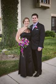 Bridesmaid And Groomsman In Black Dress And Suit With Purple Accents In The Shirt Boutonniere And Wedding Bouquet Photo C Www Wedding Bridal Party Bridal