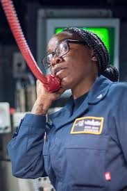 Operations Specialist 1st Class Dora Mapp, from Belle Glade, Fla.,  communicates with landing craft air cushion (LCAC) pilots assigned to  Assault Craft Unit (ACU) 5