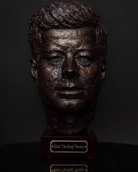 Hound Dog” by Chris Blake Chappell. Bronze and wood, 18”x10”, 2024.