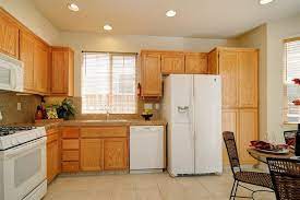 I want to paint the cabinets. Modern Kitchen With Oak Cabinets And White Appliances Novocom Top
