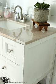 By giving it a new lick of paint and some jazzy handles, your old dresser will be unrecognizable, and your bathroom will get a makeover in the process. Powder Bathroom Vanity Makeover The Wood Grain Cottage