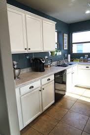 After the kitchen was totally covered and protected, mike sprayed some areas with primer. How To Paint Kitchen Cabinets White Tutorial Rise And Renovate