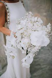 Still need convincing on the rooftop wedding? Glamorous White Bouquet With Peonies Orchids And Baby S Breath White Bouquet All White Wedding White Wedding Bouquets