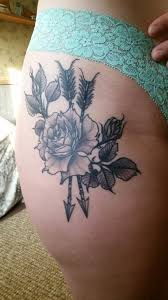 Whatever tattoo design you choose, ensure that it will look amazing even if it is small. Lovely Arrow And Black Rose Tattoo For Girl Hip Truetattoos
