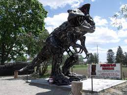 T Rex Has A New Home At Primitive Designs In Porthope T Rex Stands 20 Feet High And 40 Feet Long Made Entirely From Pa Tourist Attraction Tourist Tourism