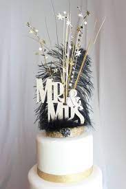 A wedding cake topper is a small model that sits on top of a wedding cake, normally a representation of the couple in formal wedding attire. Pin On Over The Top Cake Toppers