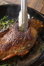 A Large Sirloin Steak Being Fried In A Cast Iron Skillet With Kitchen Tongs Being Used To Move T Top Sirloin Steak Recipe Sirloin Steak Recipes Sirloin Recipes