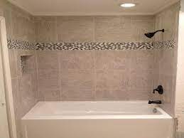 ❮ ❯ bathroom tile designs to inspire you modern akdo glass tile tub surround modern bathroom free standing tub pebble floor porcelain wall 18 Photos Of The Bathroom Tub Tile Designs Installation With Contemporary Bathroom Tub Tile Ideas Id5781 Ww Tub Remodel Bathtub Remodel Bathroom Tile Designs