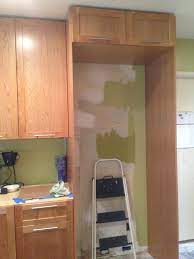 A fridge panel is composed of pieces of wood that surround a refrigerator. Fridge Surround I Don T Think This Is Right