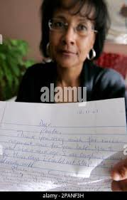Paula Nourse poses with a letter from Angolan immigrant Isaac Manuel at her  home in Dallas, Monday, Dec. 17, 2007. Nourse and other friends say Manuel  should be offered the political asylum