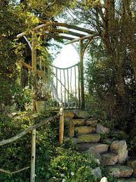 Stone Steps Lead Up To This Unusual Branch Arbor With Gate There S Also Branch Railing Along The Stone Steps Garden Gates Garden Stairs Garden Steps