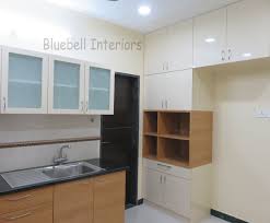 Teak Wood Cream Modular Kitchen Loft Storage In Kitchen Tall Unit For Gadgets Glass Shutters In 2020 Loft Storage Interior Teak Wood