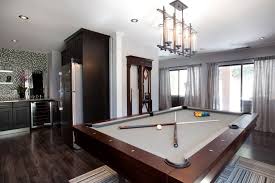 Brunswick Pool Table The Treviso With A Brunswick Centennial Cue Rack In The Background From The Property Brothers Sh Pool Table Room Pool Table Patio Flooring