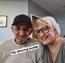 Elderly lady compliments young mailman's outfit