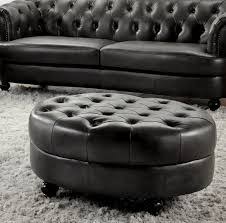 Bright, contrasting color patterns throughout this living room, featuring neutral toned sofa next to teal button tufted fabric ottoman with dark wood arrow feet. Leather Ottoman Coffee Table You Ll Love In 2021 Visualhunt