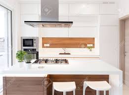 Gec cabinet depot brings you exclusive designer collection of functional and elegant walnut so, if you are fascinated by this choice of cabinetry and want to invest in this style of walnut cabinets in minnesota, usa, then you should. Modern Elegant White Kitchen With Walnut Island Stock Photo Picture And Royalty Free Image Image 67951172