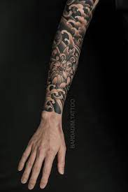 This tattoo includes a black and white inked lion's face with two roses below the lion. Japanese Sleeve Tattoo Chrysanthemum Sleeve Black And Grey Sleeve Japanese Sleeve For Men Japanese Sleeve Tattoos Traditional Tattoo Sleeve Sleeve Tattoos