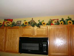 Sunflower is the most beautiful flower to be picked up as a decor theme for your kitchen as it is the most integral part of the house. Decorating Top Of Cabinets With Sunflowers Modern Home Design And Decor