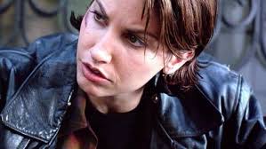 Gina Gershon's eyes looking at Jennifer with enough heat to melt Ms Tilly.