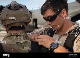 Aircrew Survival Equipmentman 1st Class Nelson Cothren, assigned to  Explosive Ordnance Disposal Mobile Unit (EODMU) 5, conducts checks prior to  a free fall jump from a C-130 Hercules during military free fall