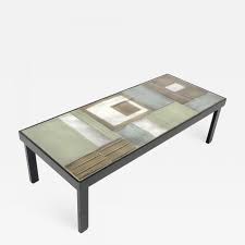 This coffee table is made of metal and powder coated finish with a ceramic top. Roger Capron French Ceramic Artist Roger Capron Ceramic Tile Coffee Table