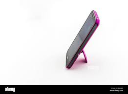 An LG G2 smart phone in a pink case ...