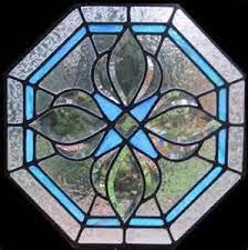 Its body has a swirl of earthy greens, as captivating as the effect a watercolor brush dipped into a glass of water has. Octagonal Shaped Stained Glass Window Stained Glass Ornaments Stained Glass Windows Stained Glass Bevels