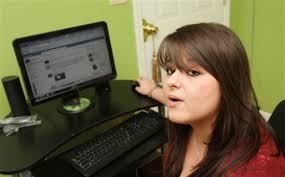 Lesbian teen in prom flap sues, returns to school