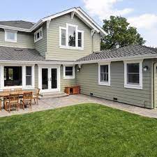 Colonial revival green stone (sw2826); Green House With Grey Roof Liveable Green By Sherwin Williams Exterior Paint Colors For House House Paint Exterior House Exterior