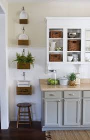 It's not only the type of wood used that dates it, but also the colour of the stain. White Bead Board Back Splash Two Toned Kitchen Cabinets Grey Bottom White Upper Wood Floors Hang Kitchen Design Kitchen Remodel Light Grey Kitchen Cabinets