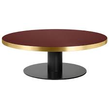 The golden leaf round coffee table represents a blend of modern style and superior craftsmanship. 2 0 Round Coffee Table Cherry Red Glass Black Rouse Home