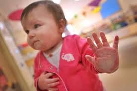 A child looks through a glass door in the recently