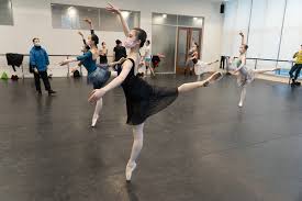 ballet performers dance around the