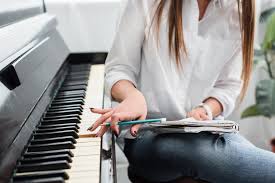 Beginners guide to playing piano: Cropped View Of Girl In White Shirt With Notebook Playing Piano And Composing Music At Home Free Stock Photo And Image