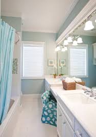 The crisp white bathing area and sink pop against the sea of blue penny tiles. Blue Bathroom Ideas With A Coastal Beach Ocean Vibe Coastal Decor Ideas Interior Design Diy Shopping