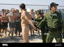 Police forces arrest nude G8 protesters that trespassed the prohibited zone  in Heiligendamm, Germany, 08 June 2007. A dozen of nude demonstrators  protested in the shallow waters of the prohibited zone. Photo: