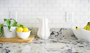 Smaller rectangular tiles marshalled in tidy rows align in a vertical stacked bond pattern to beautifully fill the wall space between countertops and expansive kitchen windows. How To Install A Subway Tile Kitchen Backsplash Young House Love