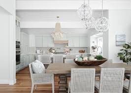 Gather around the table with comfortable dining room chairs. Gray Rattan Chairs At Brown Trestle Dining Table Transitional Dining Room
