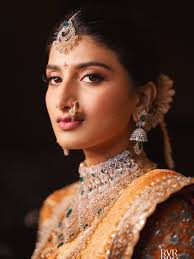My Telegu bride looked stunning in her rich Kanjivaram saree with soft pink  and mauve makeup to match. Her braid was beautifully done with flowers, and  jewelry added the perfect royal touch.