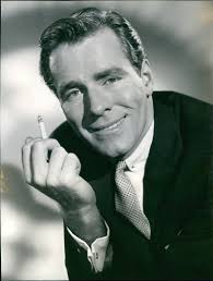 Philip Carey smoking a cigar as Tim O'Bannion in Wicked As They Come -