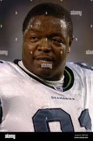 Seattle Seahawks defensive tackle Chuck Darby, left, and linebacker Julian  Peterson celebrate after the defense forced quarterback Matt Hasselbeck to  throw the ball out of bounds during football training camp Wednesday, Aug.