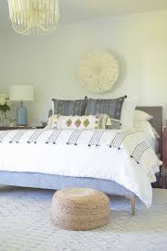 A pastel bedroom in pink, green and neutrals with a macrame chandelier and decorative baskets on the wall. Boho Chic Summer Bedroom Tour Zdesign At Home