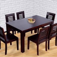 This extendable solid wood dining table has plenty of room to seat six in your dining room. Six Seater Dining Set