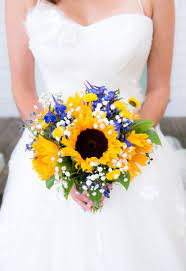Classic black and white tuxedo with black tie. Sunflower Bridal Bouquet With Accents Of Royal Blue